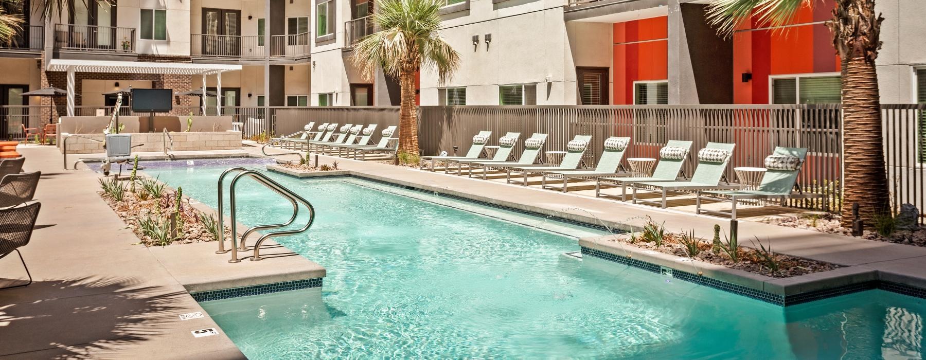 outdoor pool with lounge chairs